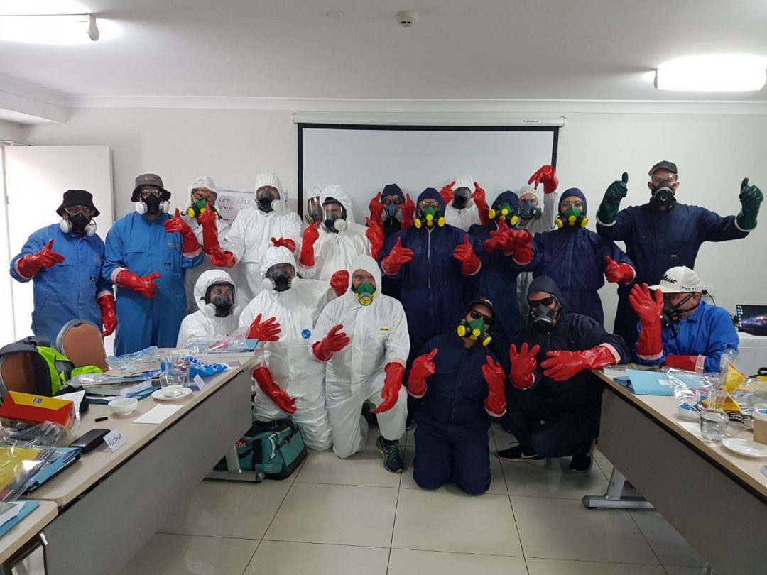 Pest management course students in classroom with protective gear